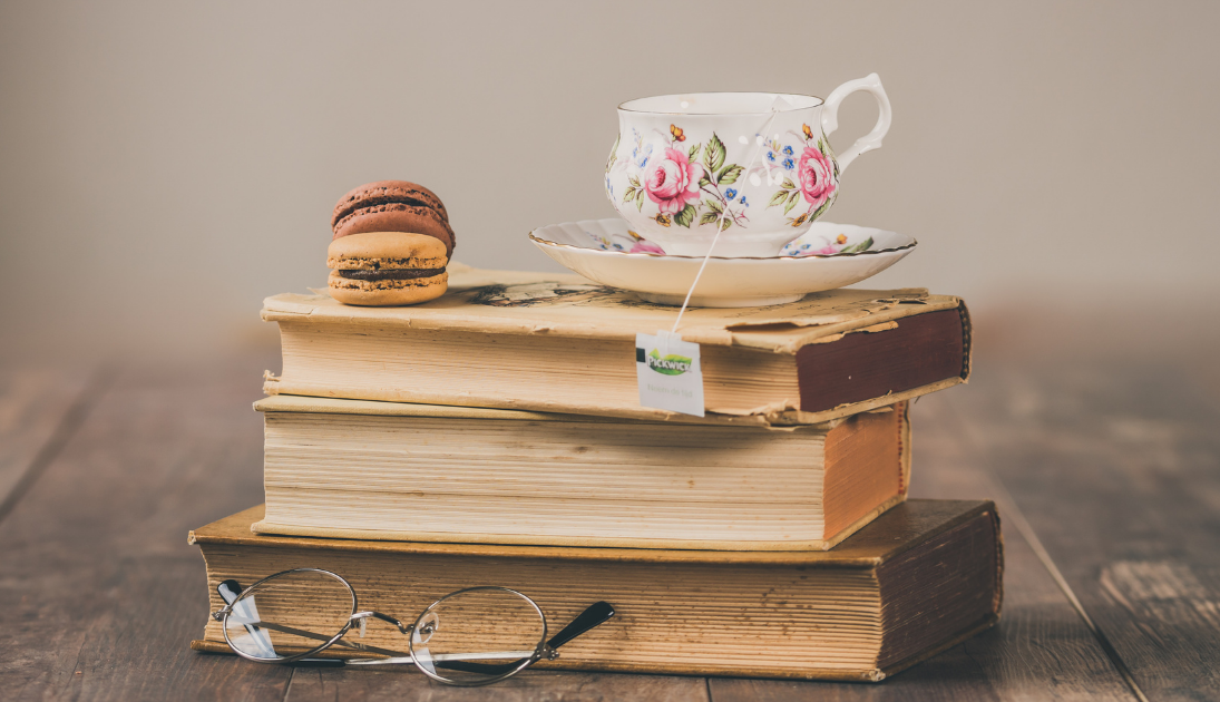 Book club stack with tea and cookies