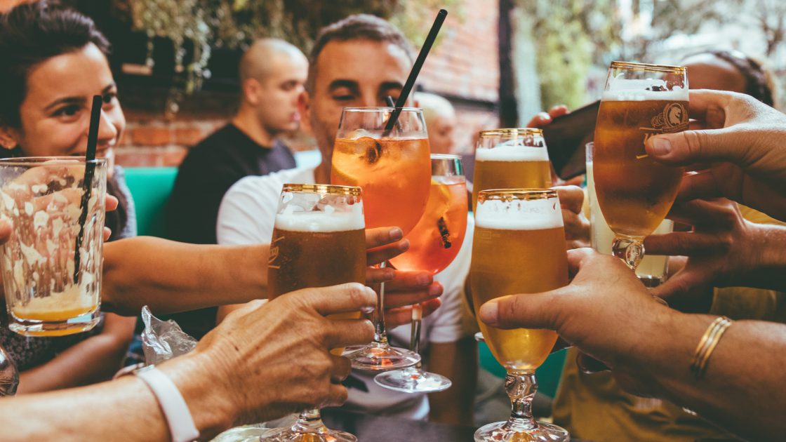 A group of people cheering at a table