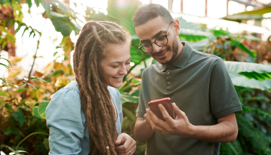 woman and man looking at cell phone