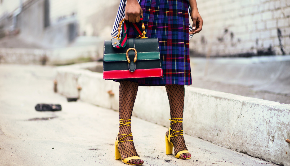 fashionable person with a striped purse and yellow shoes