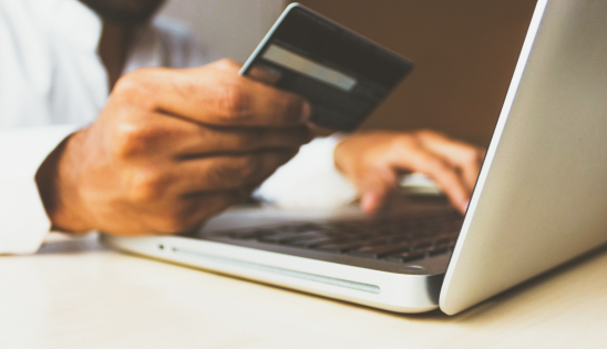 Person at laptop with credit card