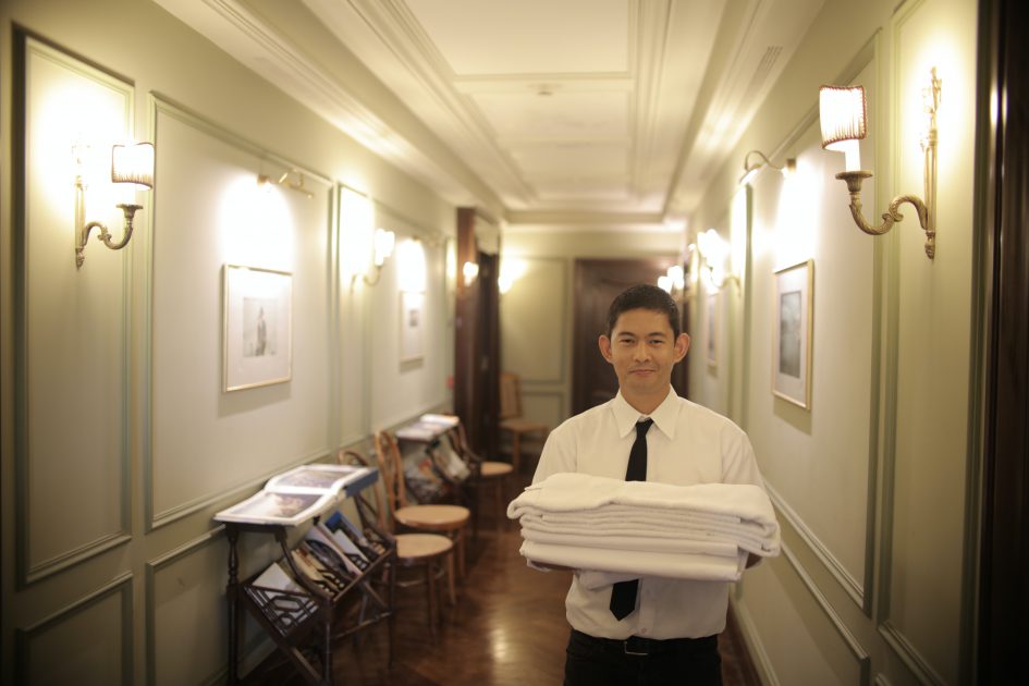 Hotel worker with towels